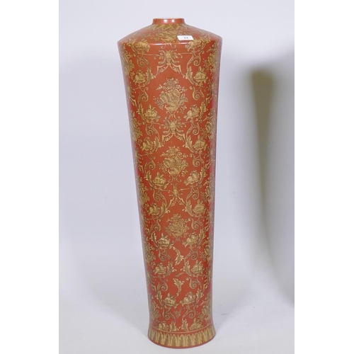 64 - A pair of oriental ceramic floor vases with raised decoration on a red glaze, 63cm high