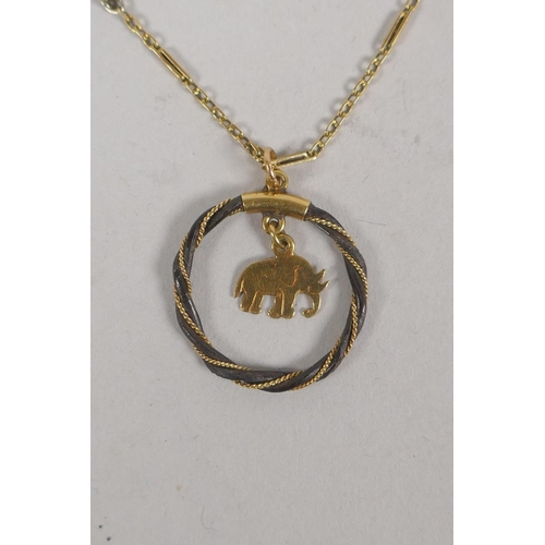 642 - A Thai yellow metal niello belt buckle and similar yellow metal necklace with metal wrapped elephant... 