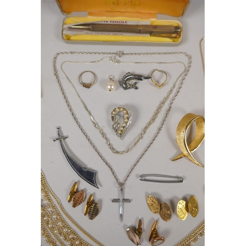 643 - A quantity of silver and other costume jewellery to include necklaces, charm bracelets, strings of p... 