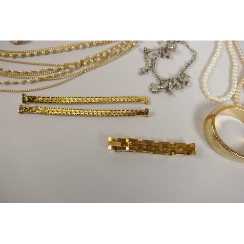 643 - A quantity of silver and other costume jewellery to include necklaces, charm bracelets, strings of p... 