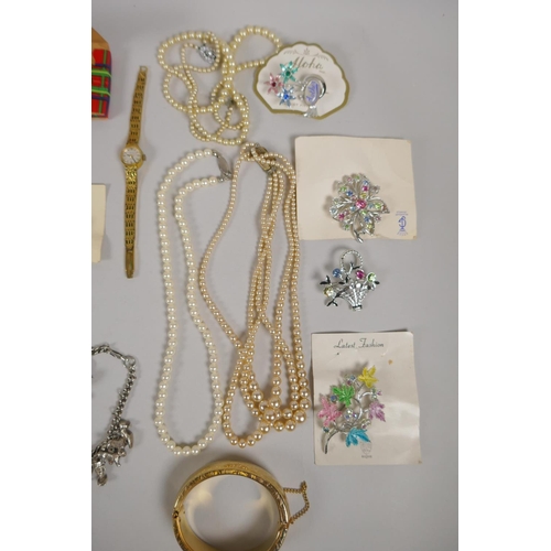 643 - A quantity of silver and other costume jewellery to include necklaces, charm bracelets, strings of p... 