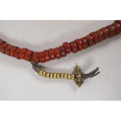 645 - A string of faux horn Tibetan mala beads with brass vajra feature beads, 60cm