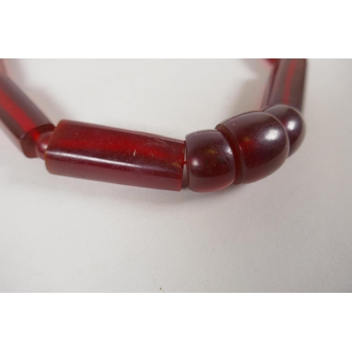 646 - An imitation cherry amber necklace, 56cm long