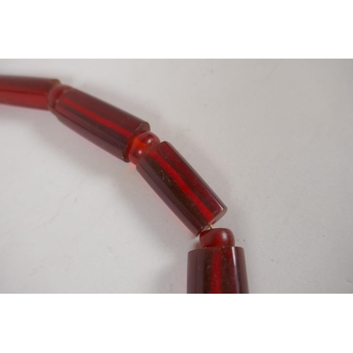 646 - An imitation cherry amber necklace, 56cm long