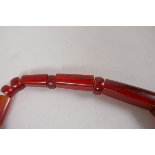 646 - An imitation cherry amber necklace, 56cm long