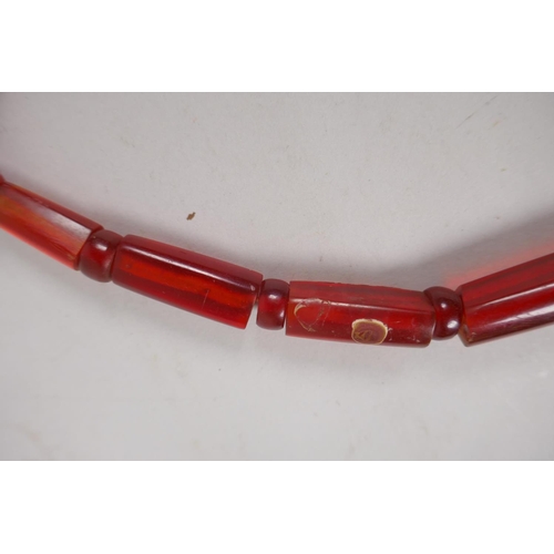 646 - An imitation cherry amber necklace, 56cm long