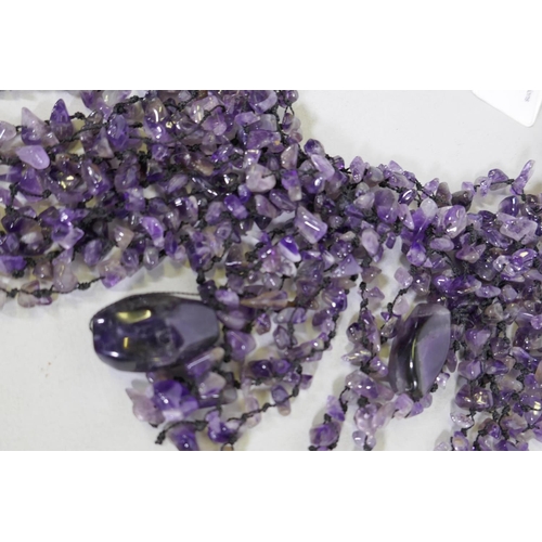 650 - An uncut amethyst stone necklace, 26cm long