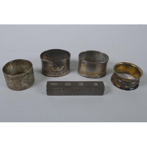 656 - A solid silver ingot, London 1973, and four hallmarked silver napkin rings, 294g