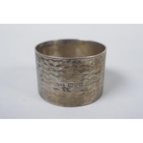 656 - A solid silver ingot, London 1973, and four hallmarked silver napkin rings, 294g