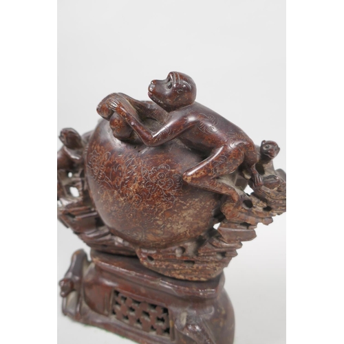 68 - An antique Chinese carved soapstone pot in the form of a peach with climbing monkeys, 17cm high