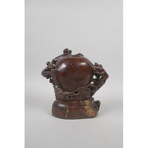 68 - An antique Chinese carved soapstone pot in the form of a peach with climbing monkeys, 17cm high