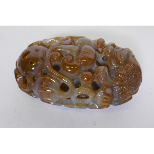 75 - A Chinese agate pierced and carved ornament in the form of a dragon and ruyi, 8cm long