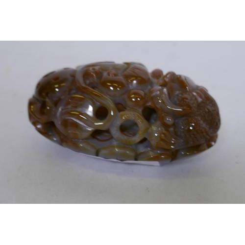 75 - A Chinese agate pierced and carved ornament in the form of a dragon and ruyi, 8cm long