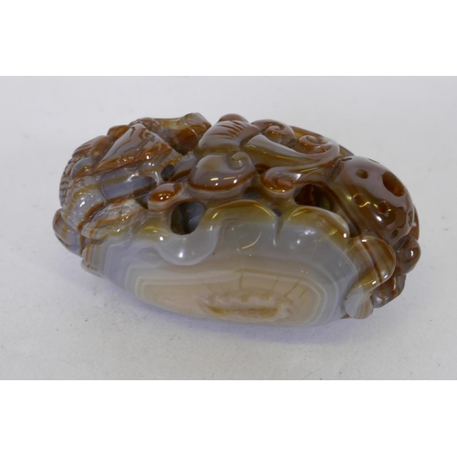 75 - A Chinese agate pierced and carved ornament in the form of a dragon and ruyi, 8cm long