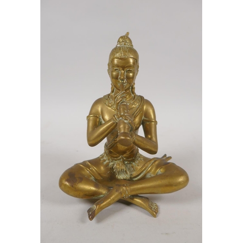 79 - An antique Thai bronze figure of a seated musician, 15cm high