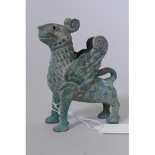 81 - A Middle Eastern verdigris bronze figure of a winged lion, 10.5cm high