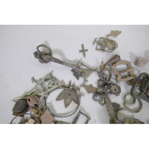 82 - Collection of bronze, brass, iron and mixed metal mounts, rings, buttons, pendants, buckles and frag... 