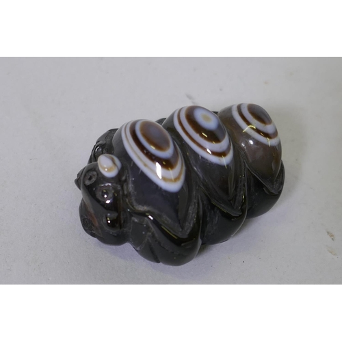 87 - An agate toggle/pendant in the form of a dragon and three eyes, 3.5cm long