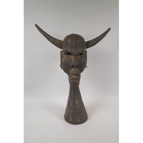 89 - A carved and painted tribal head bust of a horned deity, 44cm high