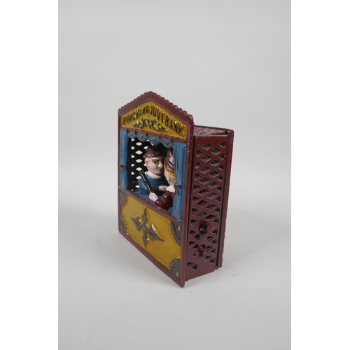 91 - A vintage style painted cast iron Punch and Judy mechanical money box, 18cm high