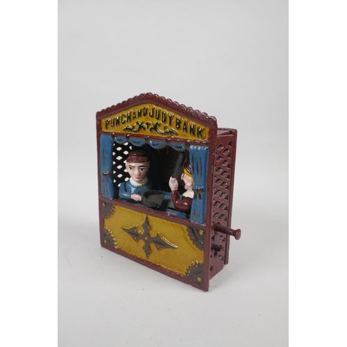 91 - A vintage style painted cast iron Punch and Judy mechanical money box, 18cm high