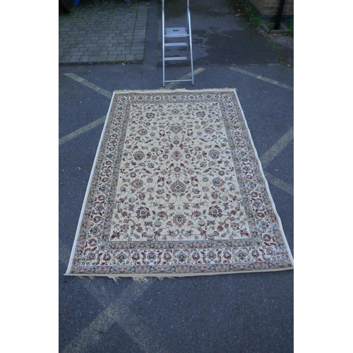 1064 - An ivory ground Kashmir rug with all over floral design, 156 x 234cm