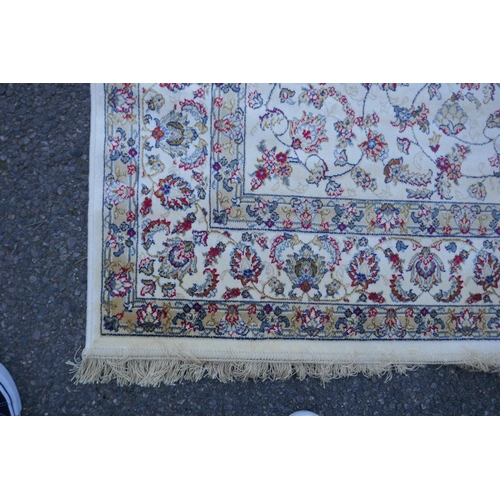 1064 - An ivory ground Kashmir rug with all over floral design, 156 x 234cm