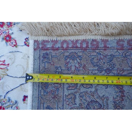 1064 - An ivory ground Kashmir rug with all over floral design, 156 x 234cm