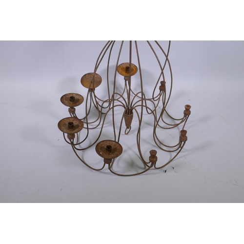 1073 - A wrought iron nine branch candle chandelier, AF, 72cm drop