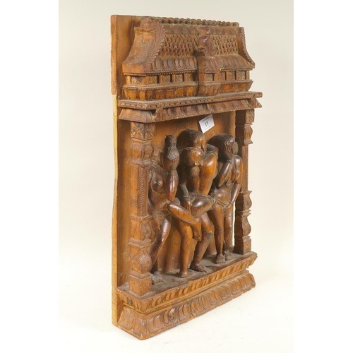 11 - An Indian wood plaque carved with an erotic scene, 29 x 48cm