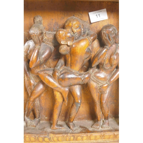 11 - An Indian wood plaque carved with an erotic scene, 29 x 48cm