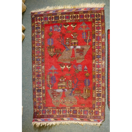 1101 - A red ground oriental carpet with a Chinese willow pattern design, and an Afghan red ground prayer m... 