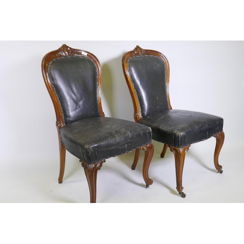 1111 - A pair of C19th Holland & Son walnut side/dining chairs with carved palmette decoration, studded... 