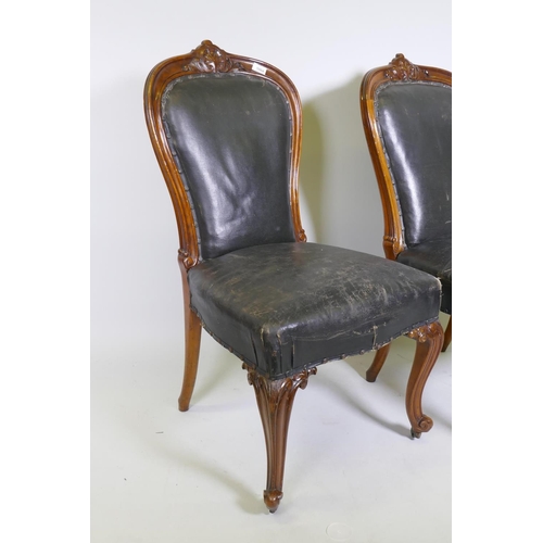 1111 - A pair of C19th Holland & Son walnut side/dining chairs with carved palmette decoration, studded... 