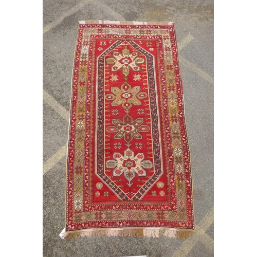 1120 - An antique Armenian red ground Karabagh rug, 135 x 270cm