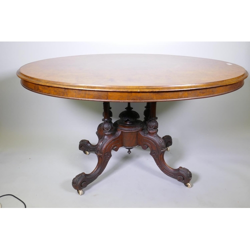 1124 - A good Victorian burr walnut loo/centre table with tilt top, raised on four carved columns on cabrio... 