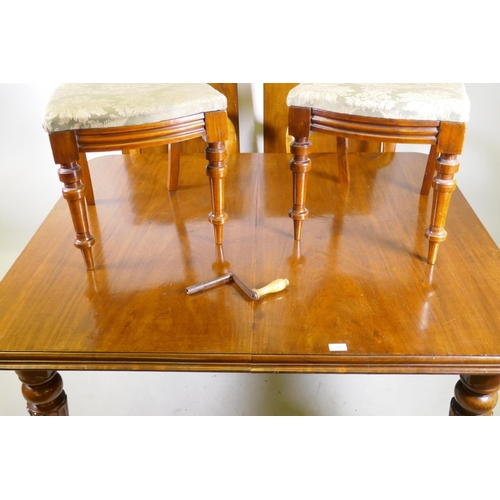 1166 - A Victorian mahogany windout dining table with two extra leaves, raised on turned and fluted support... 