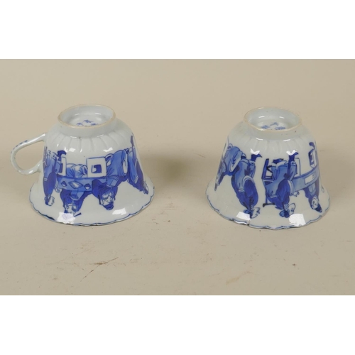 14 - Pair of Chinese blue and white porcelain tea cups, decorated with men eating and gaming, KangXi mark... 