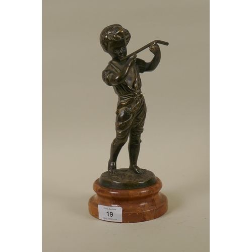 19 - An antique solid cast bronze figure of a boy with a flute mounted on a marble base, 28cm high