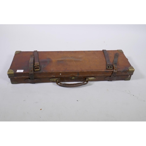 2 - Antique oak and leather gun case with brass mounts, with fitted interior containing tools and bottle... 