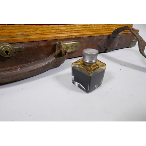 2 - Antique oak and leather gun case with brass mounts, with fitted interior containing tools and bottle... 