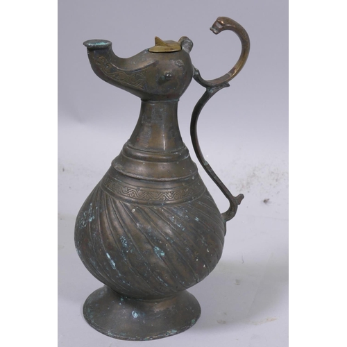 3 - A Middle Eastern bronze ewer with zoomorphic style spout, 23cm high