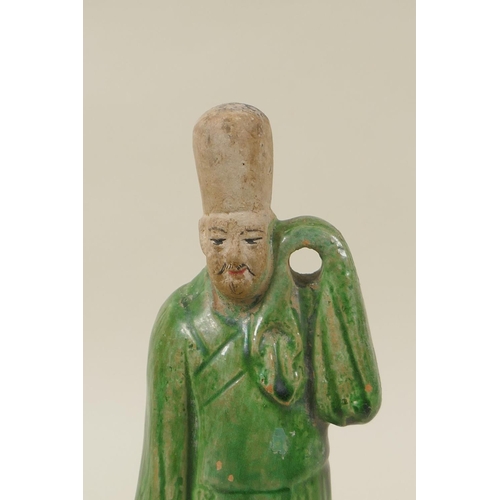 33 - A Chinese Tang Dynasty (618-907AD) green glazed terracotta figure of a male court attendant, with pa... 