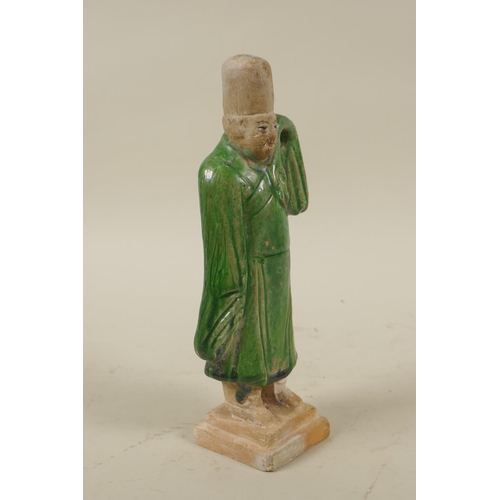 33 - A Chinese Tang Dynasty (618-907AD) green glazed terracotta figure of a male court attendant, with pa... 