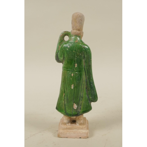 33 - A Chinese Tang Dynasty (618-907AD) green glazed terracotta figure of a male court attendant, with pa... 