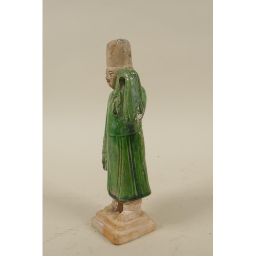 33 - A Chinese Tang Dynasty (618-907AD) green glazed terracotta figure of a male court attendant, with pa... 