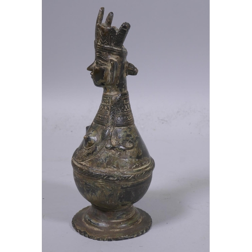 4 - A Middle Eastern bronze idol/candle holder, 22cm high