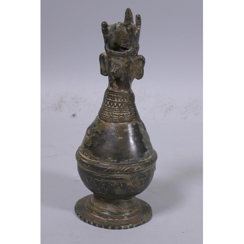 4 - A Middle Eastern bronze idol/candle holder, 22cm high