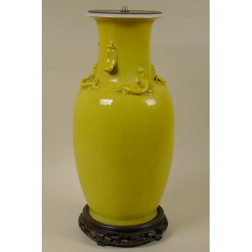 40 - Chinese yellow glazed ceramic base table lamp with raised stylised dragon decoration and pierced woo... 