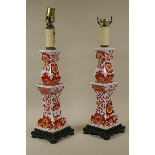 41 - Pair of porcelain table lamps with oriental style decoration raised on wood bases, 50cm high